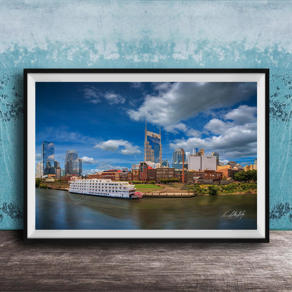 A framed photograph of the Nashville skyline, featuring the iconic skyline of Nashville, Tennessee, with the city's iconic landmarks such as the Tennessee State Capitol and the Nashville River.