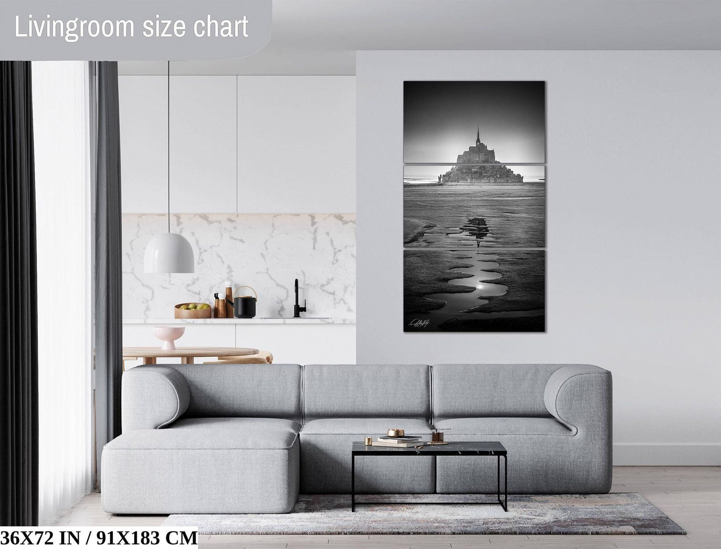 a modern living room with a gray sectional sofa, a coffee table, and a large black and white photograph of a castle on the wall.