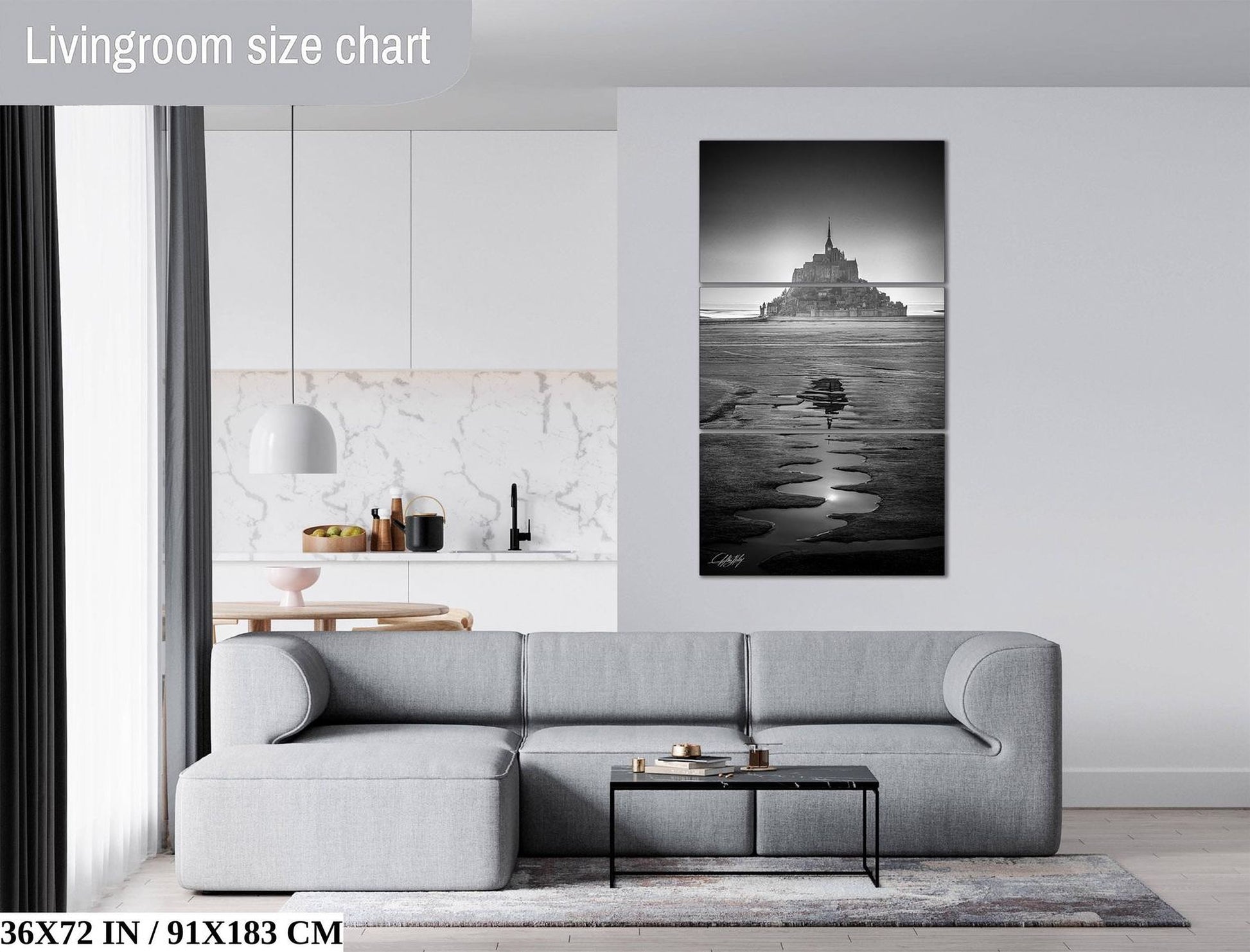 a modern living room with a gray sectional sofa, a coffee table, and a large black and white photograph of a castle on the wall.