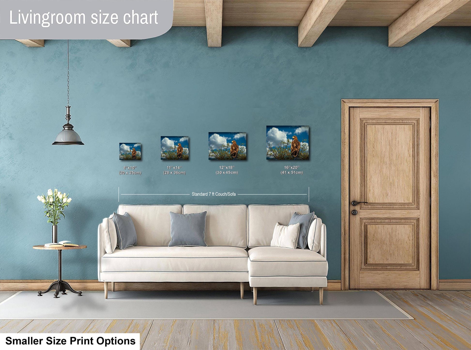 a living room with a white sofa, a wooden door, and a hanging light fixture. There are three framed artworks displayed on the wall, each with a different size and resolution. The living room appears to be designed for a smaller, more intimate space.