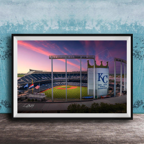 A framed photograph of a baseball stadium at sunset, with the Kansas City Royals logo prominently displayed.