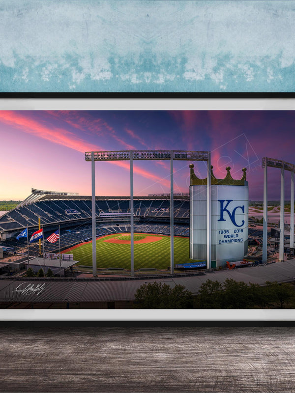 A framed photograph of a baseball stadium at sunset, with the Kansas City Royals logo prominently displayed.