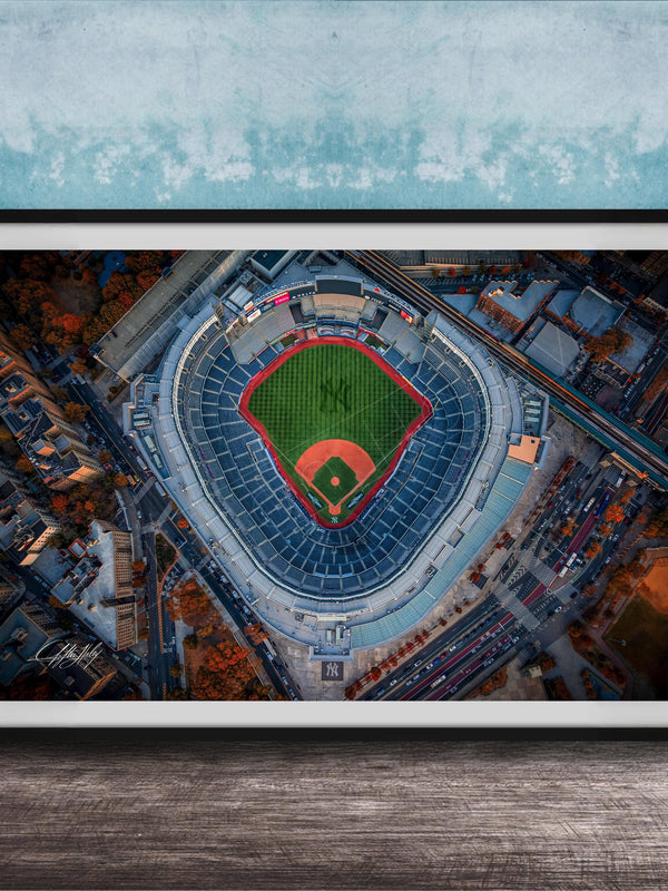The image is an aerial view of a baseball stadium, specifically the New York Yankees stadium, with the field and surrounding buildings visible.