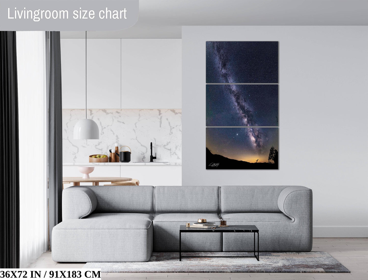 The image is a living room with a gray sofa, a coffee table, and a large wall art depicting a night sky with a galaxy.