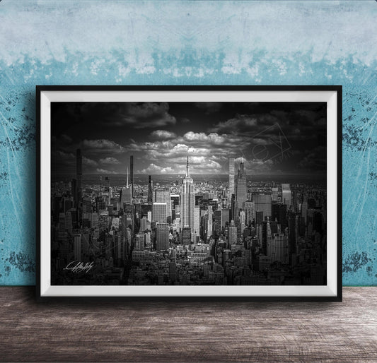 A black and white photograph of a cityscape, likely New York, with numerous tall buildings and skyscrapers in the background.