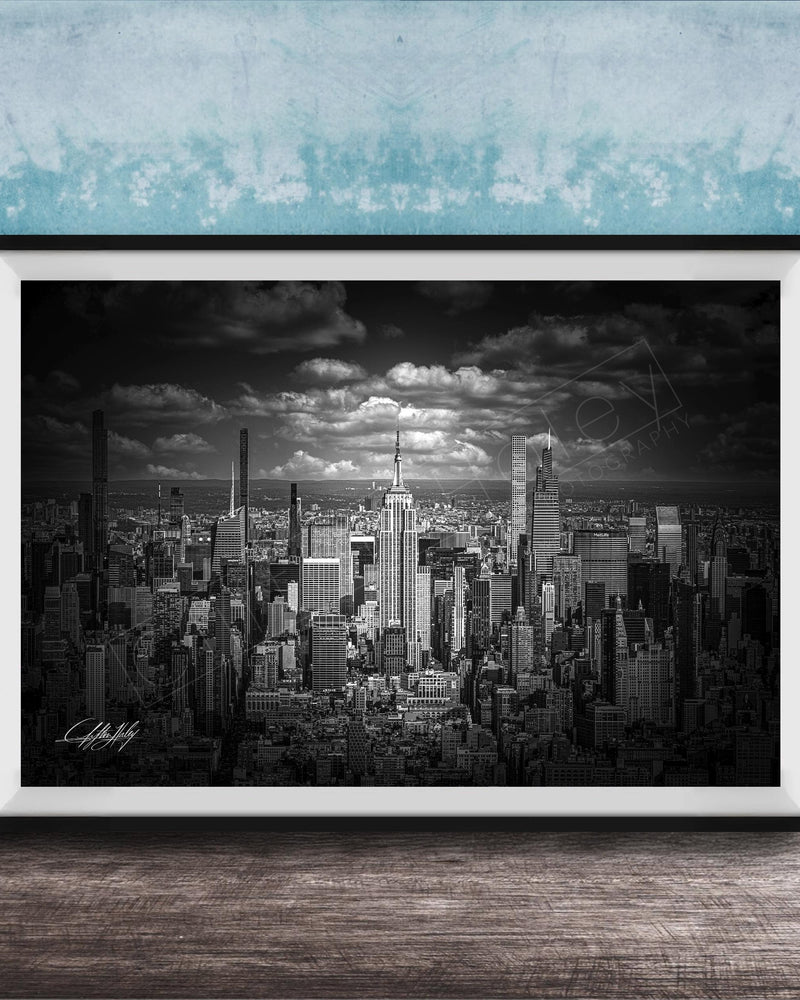 A black and white photograph of a cityscape, likely New York, with numerous tall buildings and skyscrapers in the background.