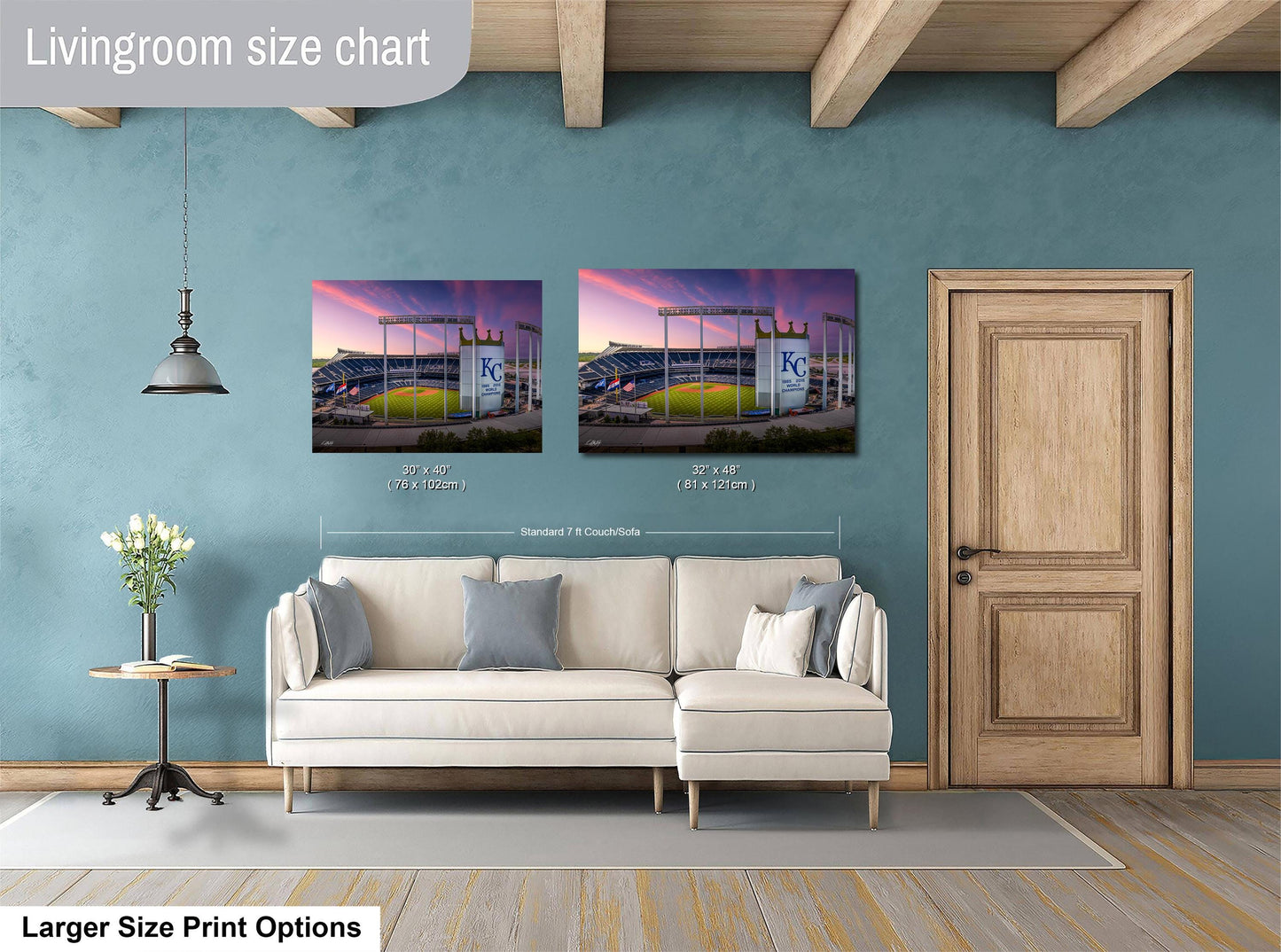 a living room with a white sofa and a wooden door. Above the sofa, there are two framed pictures of a baseball stadium, with one picture being larger than the other. The living room has a blue wall and a wooden ceiling.