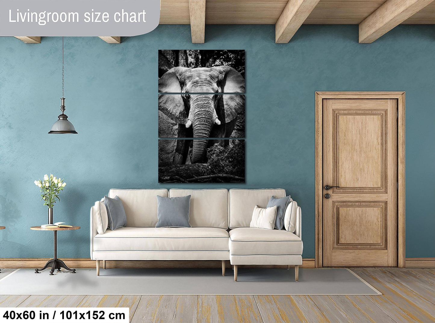 a living room with a large black and white elephant painting hanging on the wall above a white sofa.