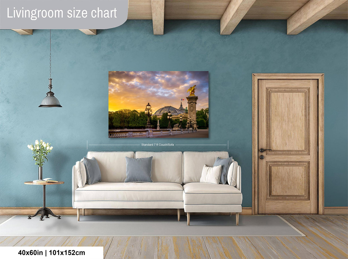 a living room with a large painting of a cityscape hanging on the wall. The painting is framed and appears to be a high-quality, professional-grade artwork. The room has a white sofa and a wooden door, creating a modern and elegant atmosphere.