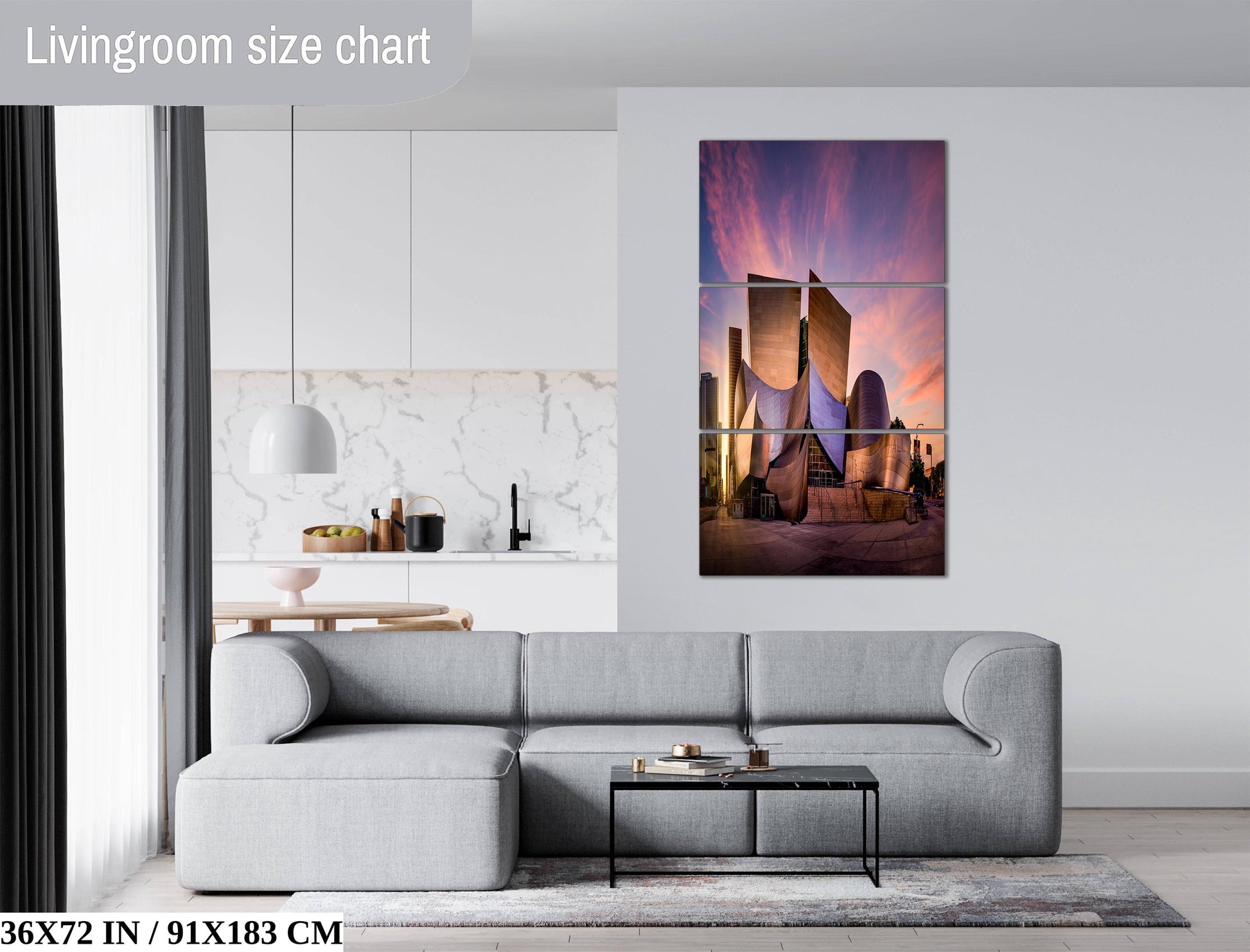 The image is a modern living room with a gray sofa, a coffee table, and a large wall art depicting a city skyline at sunset.