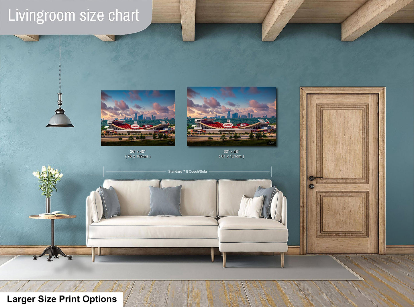 a living room with a white sofa and a wooden door. Above the sofa, there are two framed pictures of a city skyline, and the wall has a blue color. The living room appears to be well-lit and decorated.