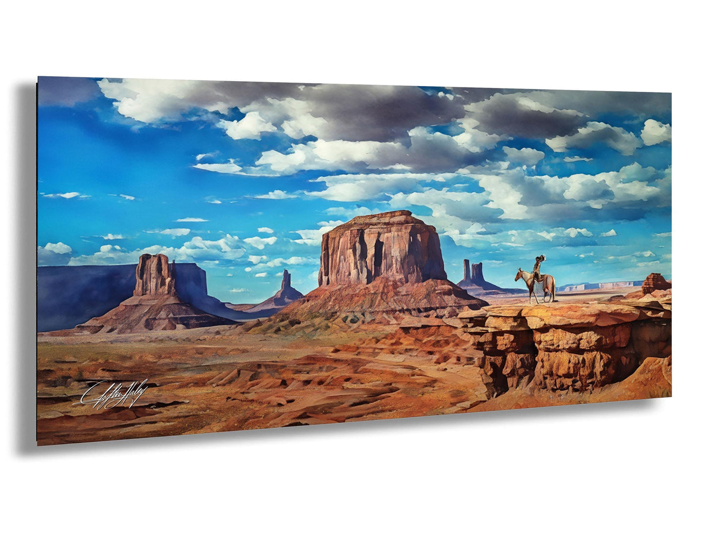 A cowboy on horseback stands in the foreground of a vast, arid desert landscape with towering rock formations and a blue sky with fluffy white clouds.