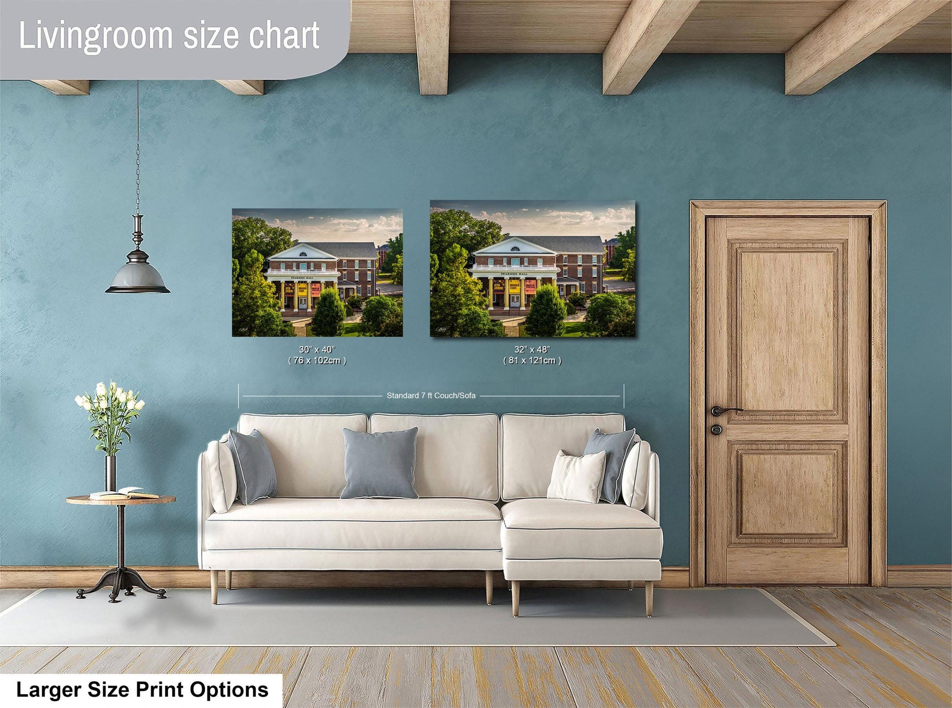 a living room with a white sofa and a wooden door. Above the sofa, there are two framed pictures of a house, one larger than the other. The larger picture is labeled as a "Livingroom size chart" and the smaller picture is labeled as a "Standard 7x7 feet".