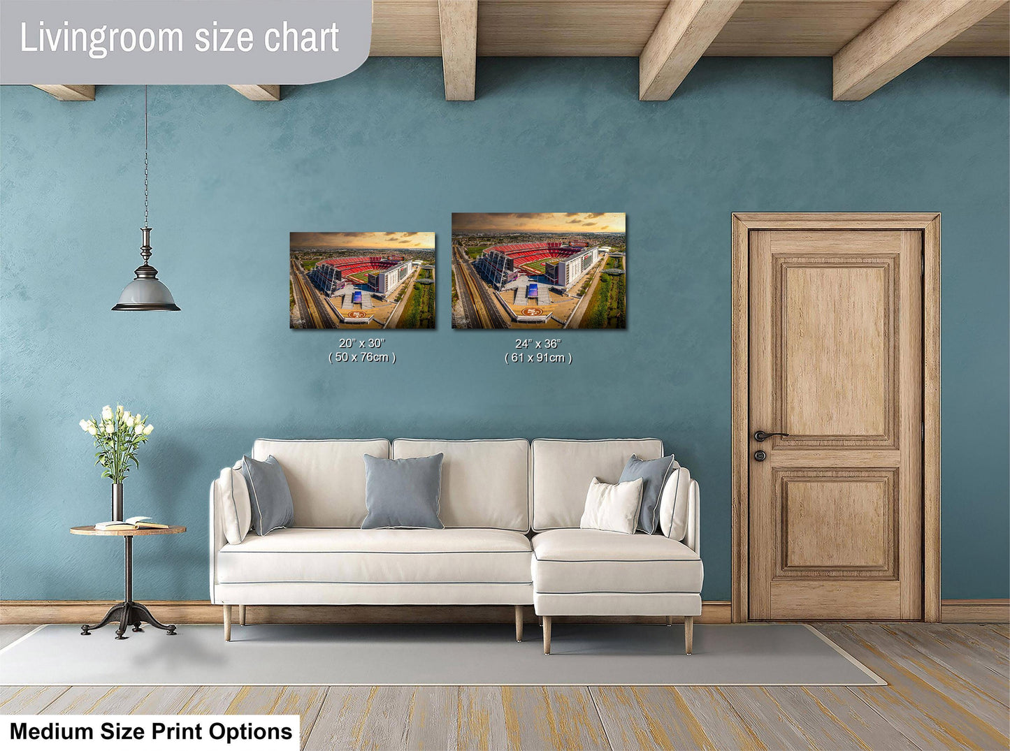 a living room with a white sofa, a wooden door, and a painting of a building on the wall. The painting is of medium size, and the sofa is of medium size as well. The living room appears to be well-decorated and spacious.