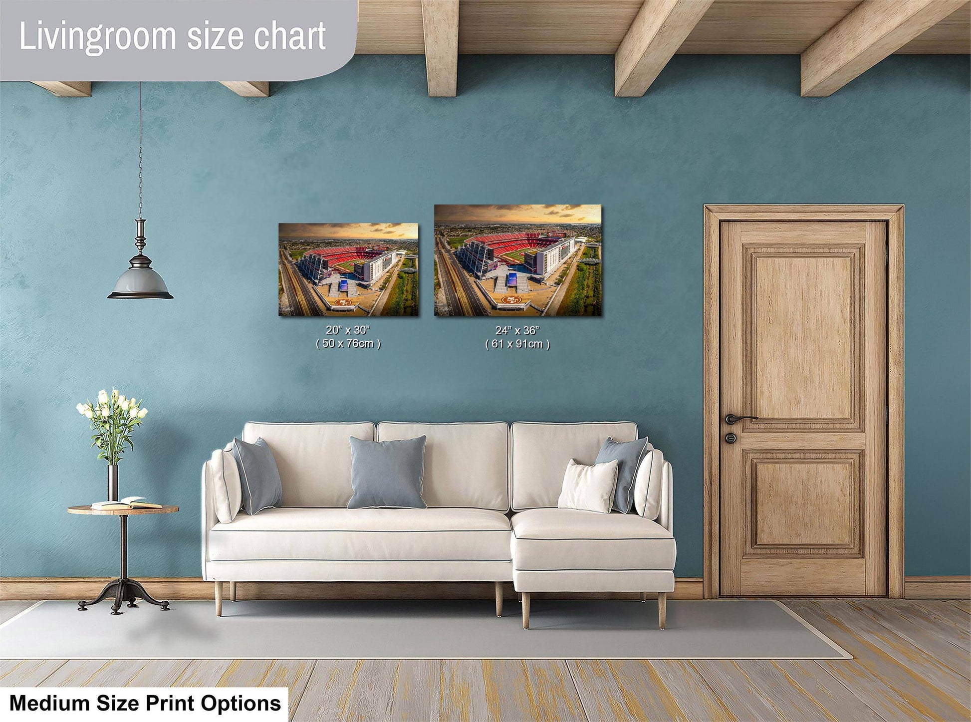 a living room with a white sofa, a wooden door, and a painting of a building on the wall. The painting is of medium size, and the sofa is of medium size as well. The living room appears to be well-decorated and spacious.