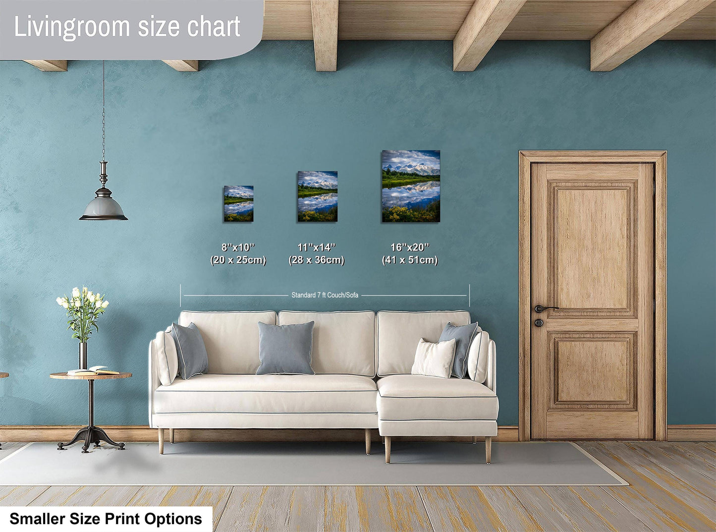 a living room with a white sofa, a wooden door, and a hanging light fixture. There are three framed landscape paintings of varying sizes displayed on the wall, with the largest one being 16 x 20 inches and the smallest one being 11 x 14 inches. The room has a blue wall and a wooden floor.