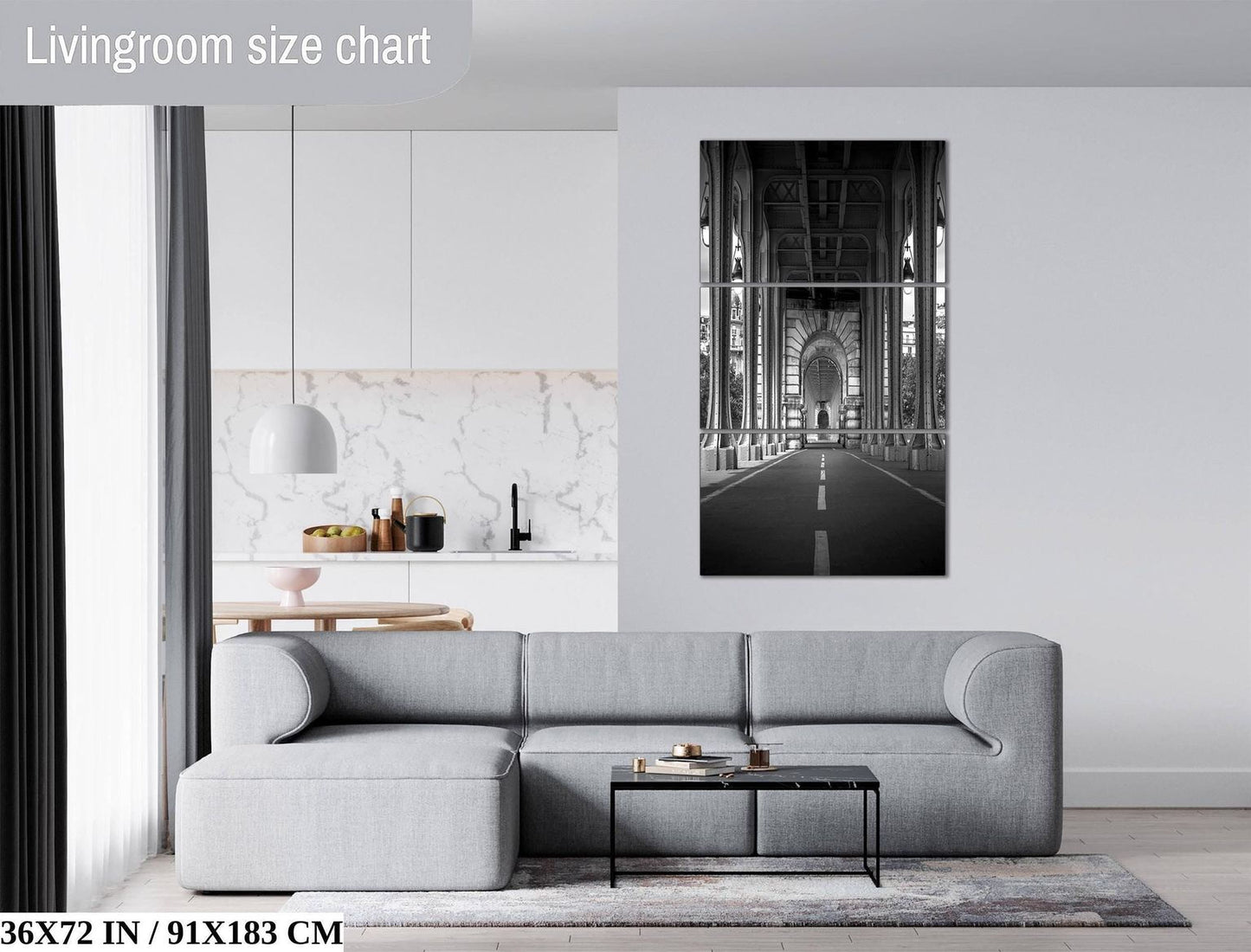 a modern living room with a gray sectional sofa, a coffee table, and a large black and white photograph of a bridge hanging on the wall.