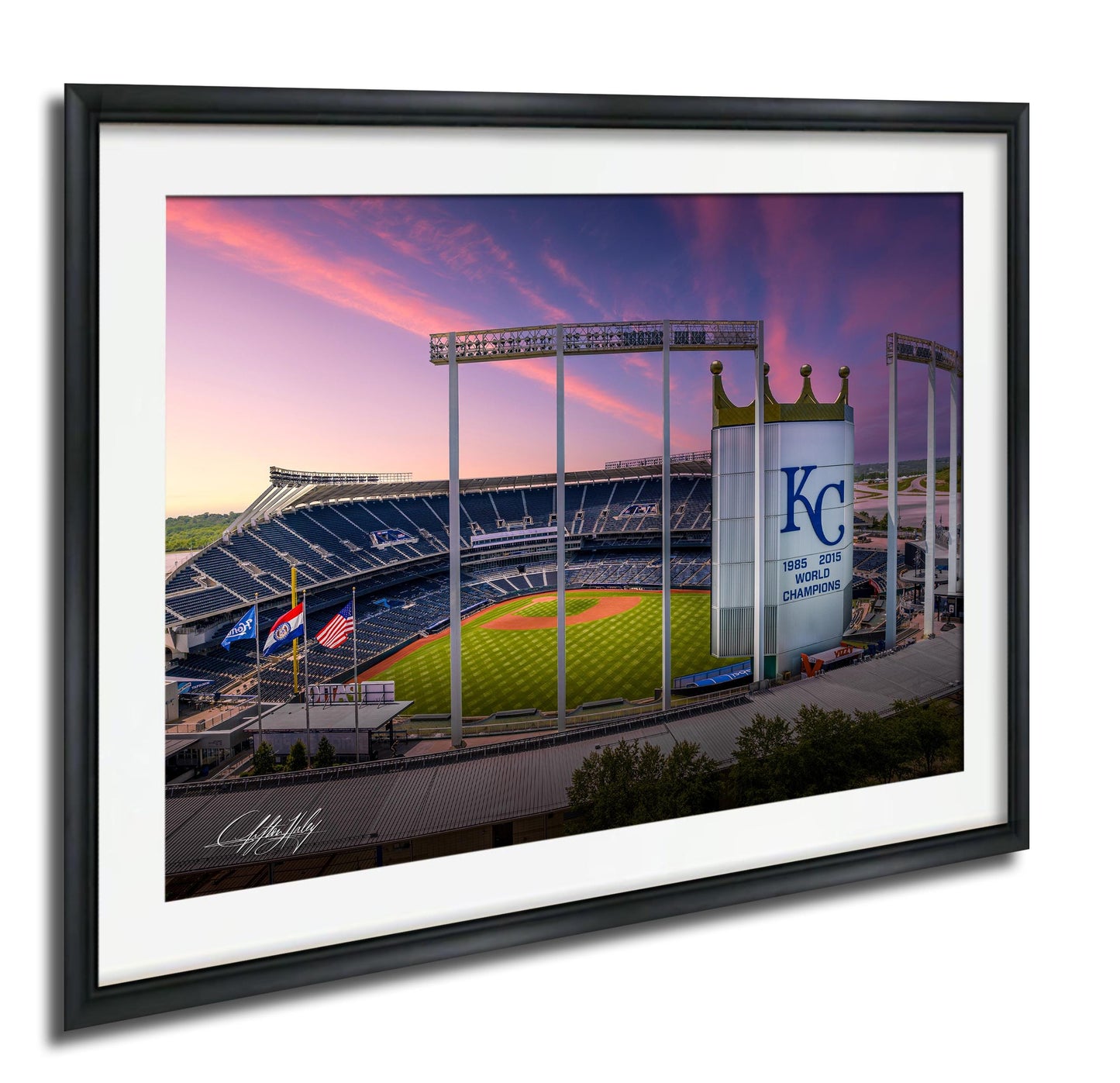 A framed photograph of a baseball stadium at sunset, with the Kansas City Royals logo visible on the outfield wall.