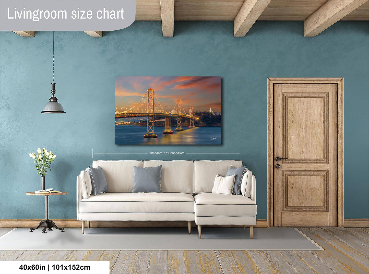 a living room with a large white sofa, a wooden door, and a painting of a bridge in the background.