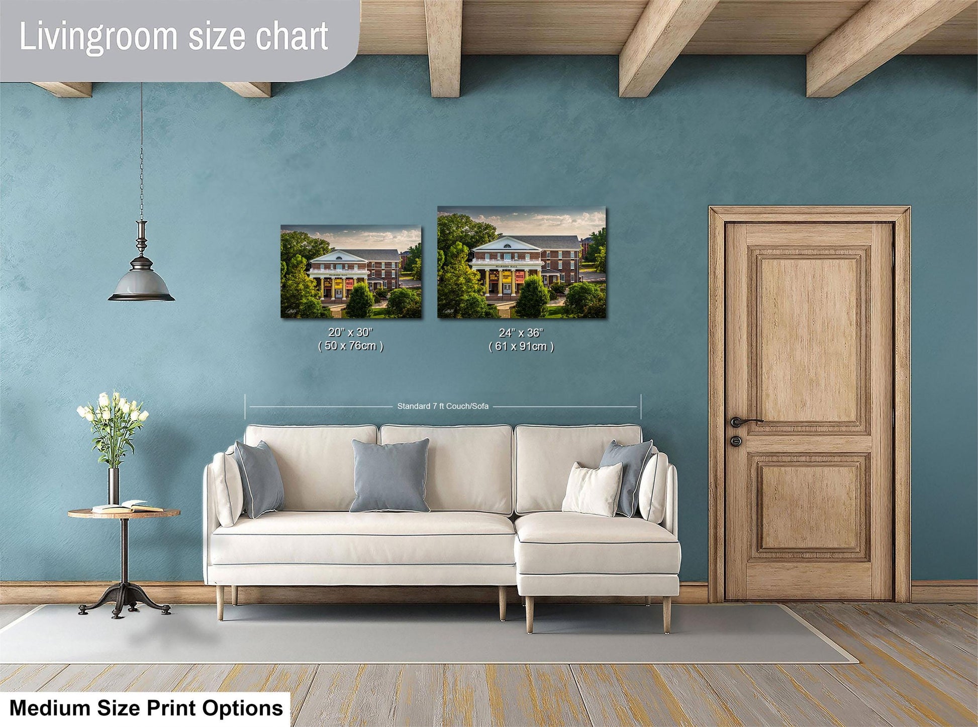 a living room with a white sofa, a wooden door, and a painting of a house on the wall. The painting is of a two-story house with a wrap-around porch. The living room is described as having a blue wall and a wooden floor.