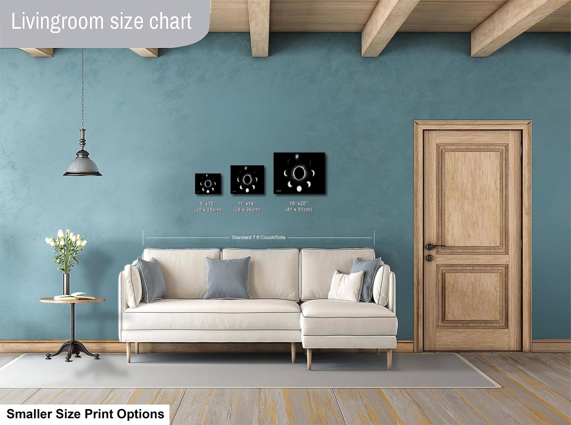 a living room with a white sofa, a wooden door, and a potted plant. The living room has a blue wall and a wooden ceiling. There are three framed artworks displayed on the wall, each with a different size and style. The image also includes text that provides information about the living room size chart and smaller print options.
