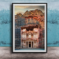 A framed image of the ancient Monastery carved into a cliff face, with a dramatic sky and rocky landscape in the background.