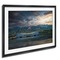 a large white structure with a curved roof, possibly a monument or building, situated in a mountainous landscape with a cloudy sky and a sunset in the background.