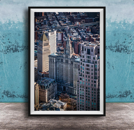 The image is a framed aerial view of a cityscape, showcasing a mix of tall buildings and skyscrapers.