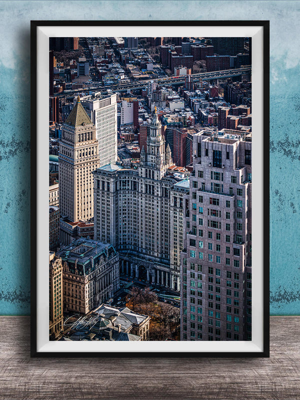 The image is a framed aerial view of a cityscape, showcasing a mix of tall buildings and skyscrapers.