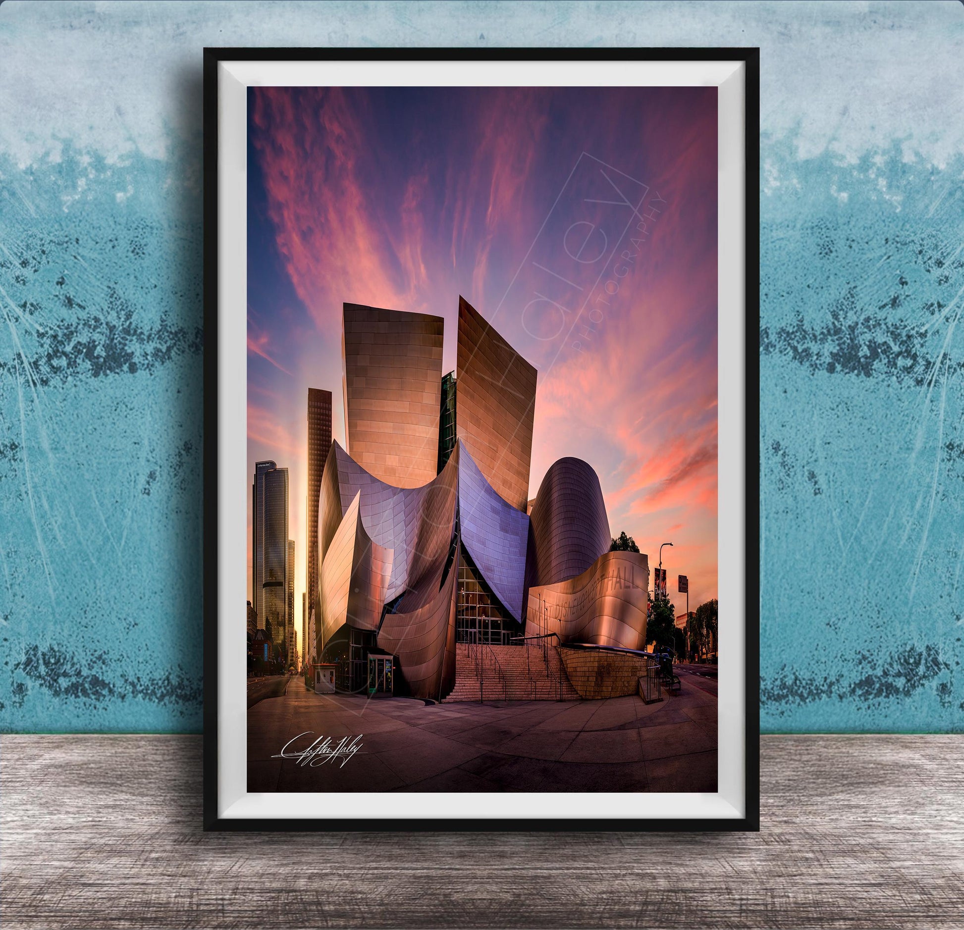 A framed photograph of the Guggenheim Museum in Los Angeles, California, with its distinctive curved architecture and vibrant sunset sky in the background.