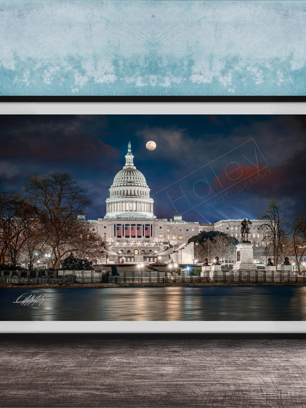 the United States Capitol building at night, with the moon visible in the sky.