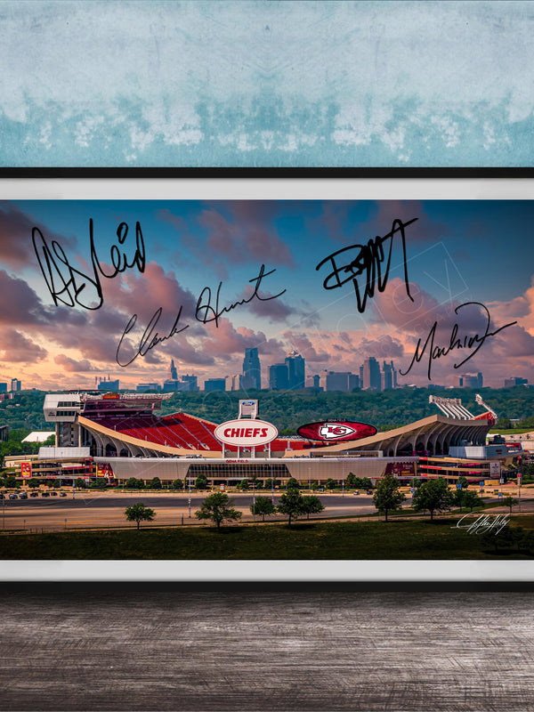 A framed photograph of a football stadium with the word "CHIEF" prominently displayed, along with the signatures of several people.