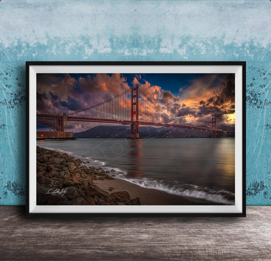 a stunning sunset over the Golden Gate Bridge, with the bridge's iconic red towers silhouetted against the vibrant sky. The calm waters of the bay reflect the warm hues of the setting sun, creating a serene and picturesque scene.