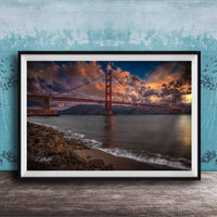 a stunning sunset over the Golden Gate Bridge, with the bridge's iconic red towers silhouetted against the vibrant sky. The calm waters of the bay reflect the warm hues of the setting sun, creating a serene and picturesque scene.