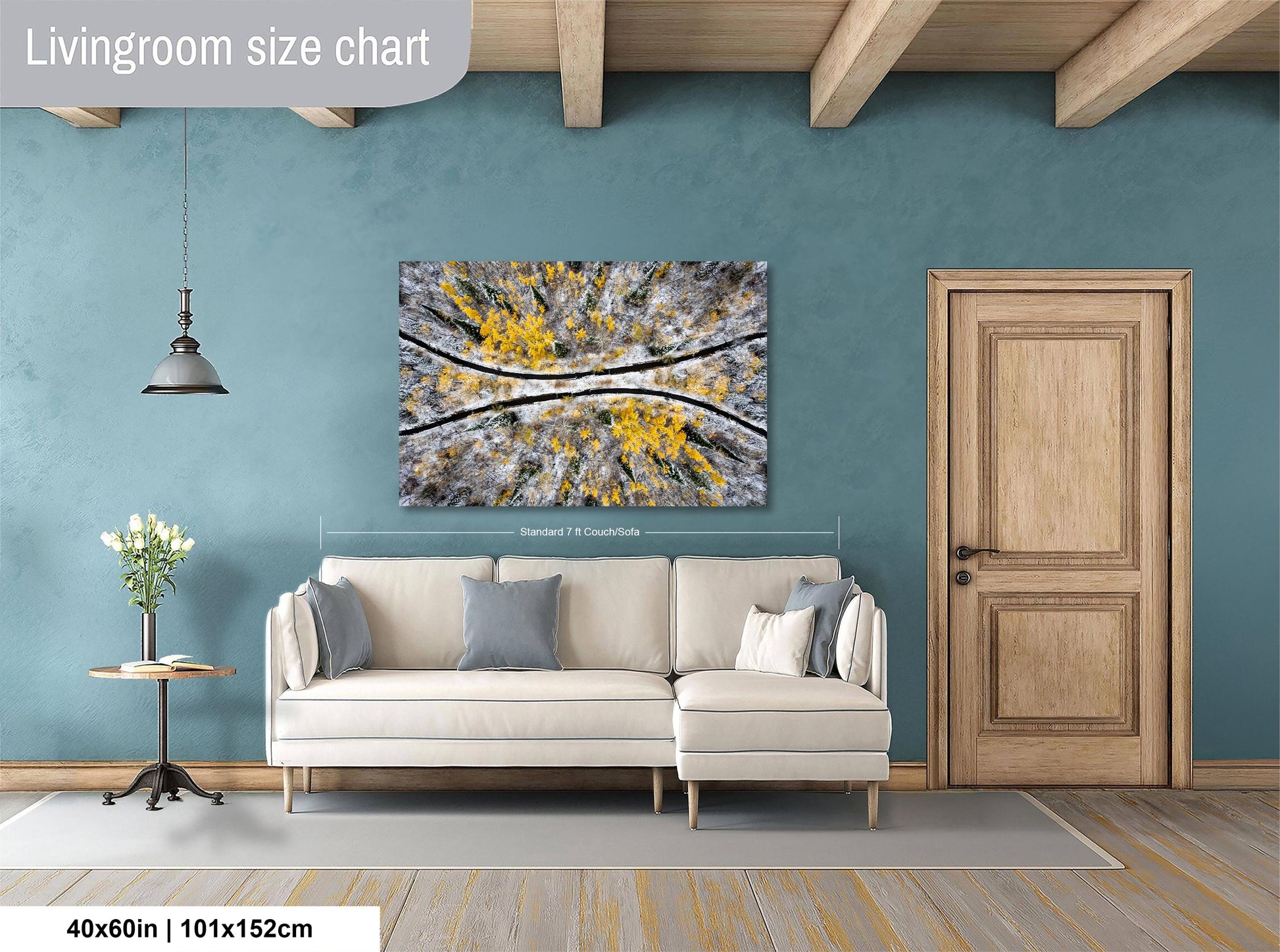 a living room with a white sofa, a wooden door, and a large abstract painting on the wall.