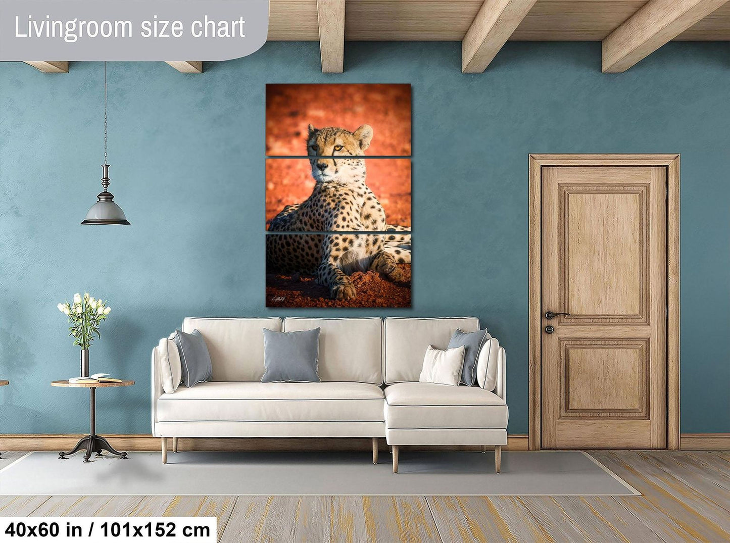 a living room with a large white sofa, a wooden door, and a painting of a cheetah on the wall.