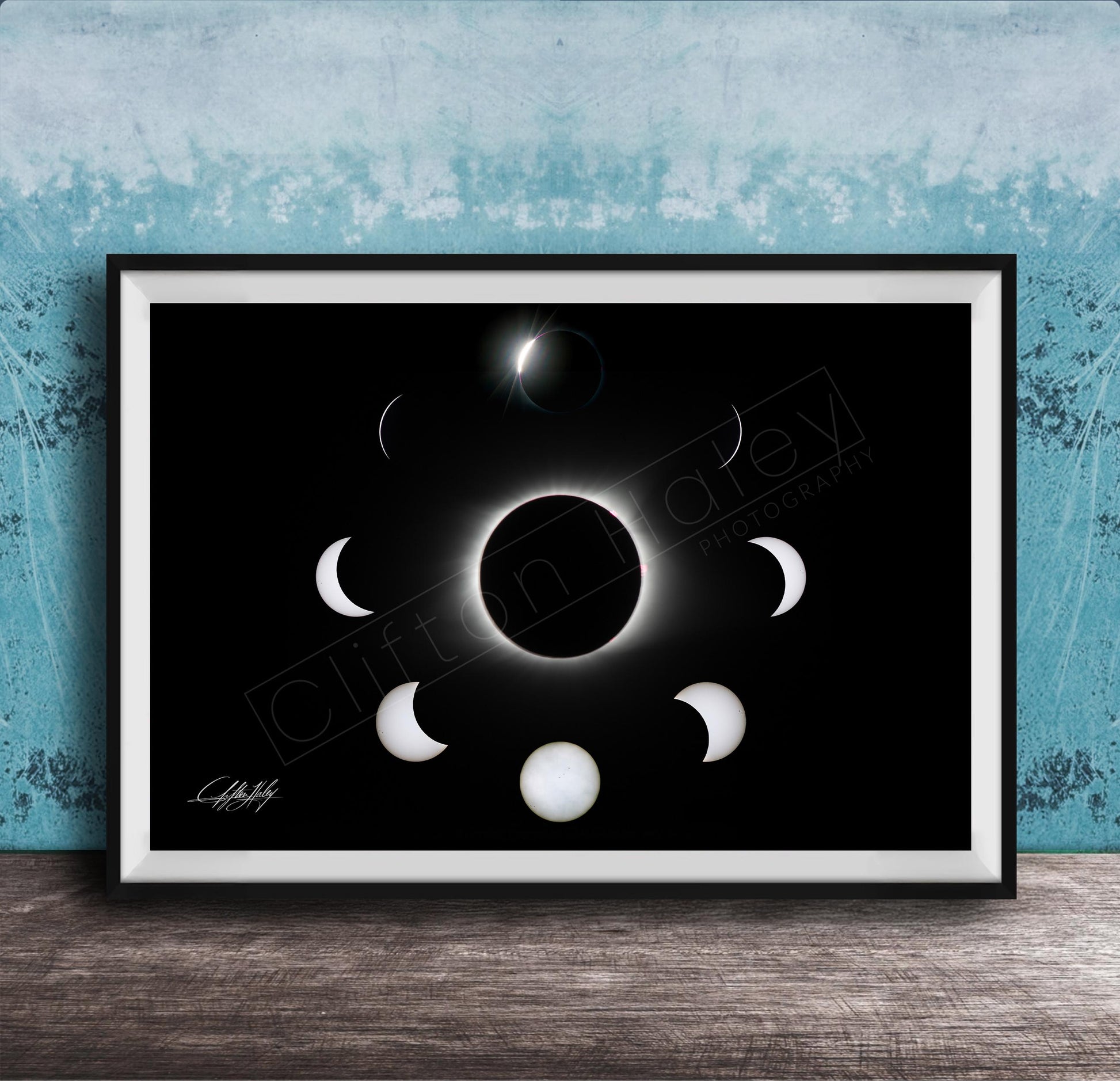 The image is a framed poster depicting the solar eclipse, showing the moon's phases around the sun.