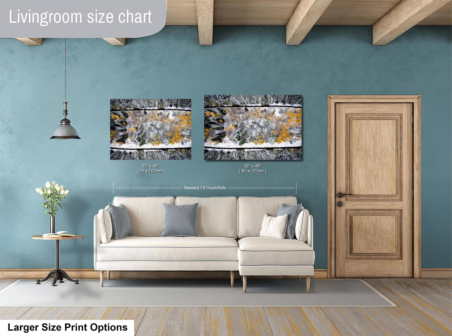 a living room with a white sofa, a wooden door, and two framed pictures hanging on the wall.