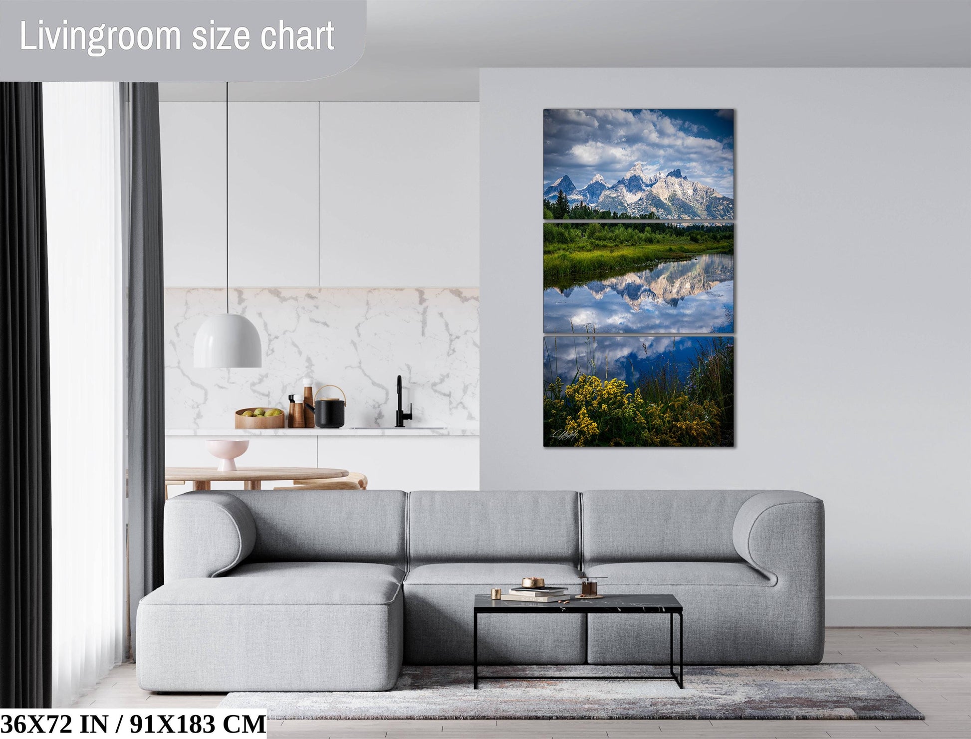 The image is a living room with a gray sofa, a coffee table, and a large landscape painting depicting a serene mountain scene with a lake and mountains reflected in the water.