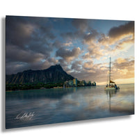 a serene scene of a sailboat gently floating on a calm body of water, with a city skyline in the background and a majestic mountain range in the distance.
