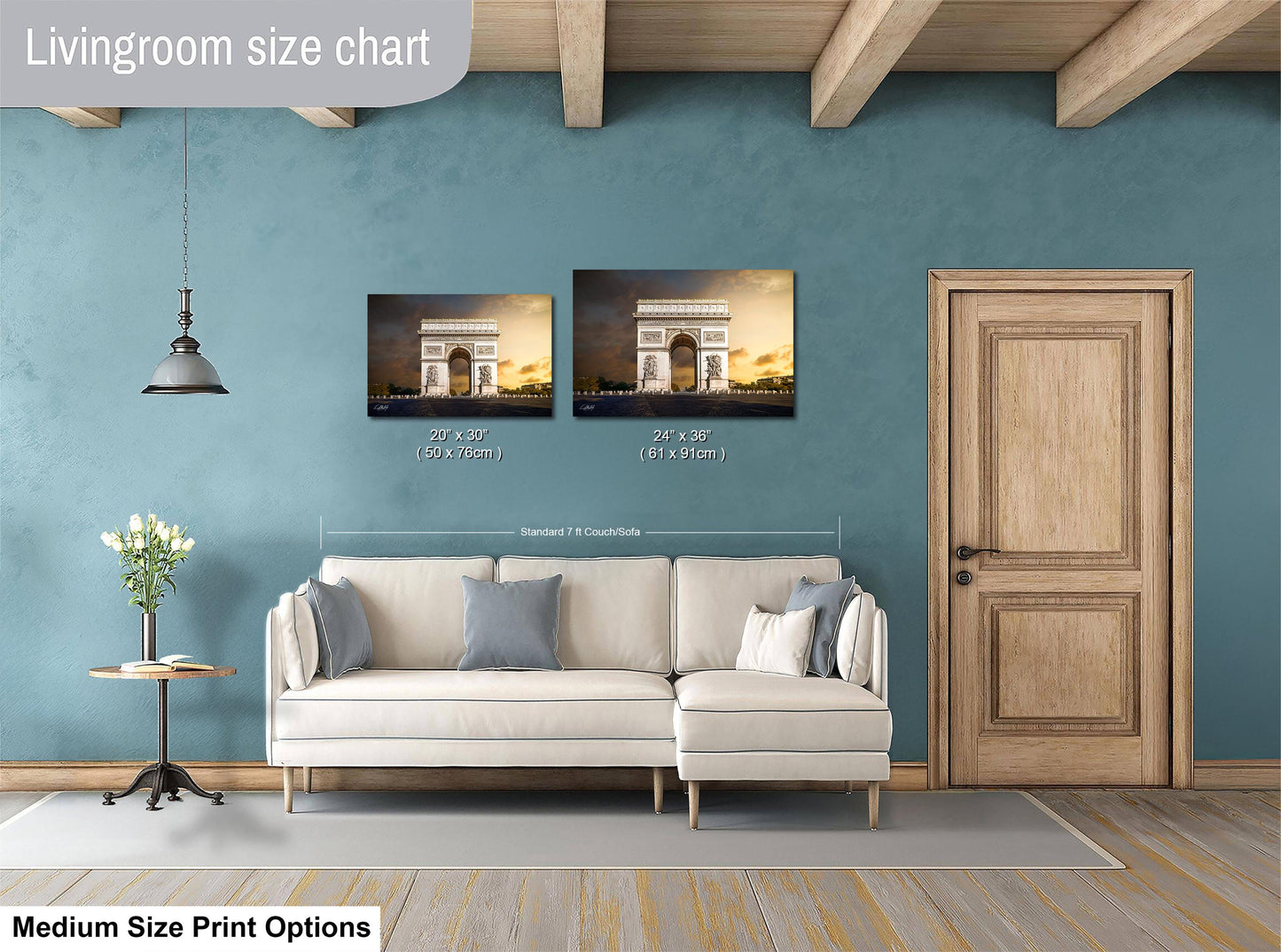 a living room with a white sofa, a wooden door, and a painting of the Arc de Triomphe on the wall.