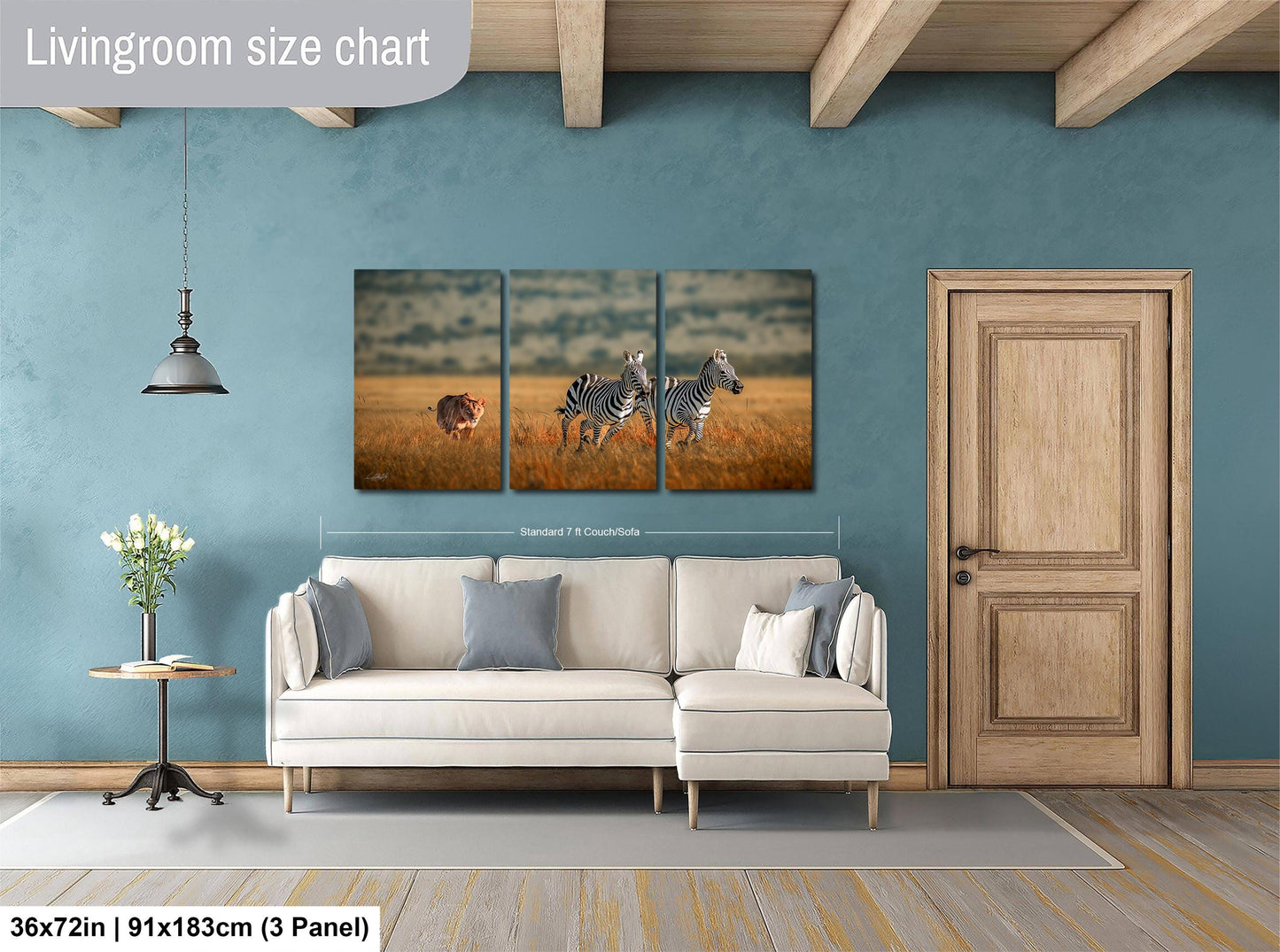The image is a living room with a large wall art depicting two zebras in a field. The wall art is a collage of three smaller images, and the living room has a white sofa, a wooden door, and a small table with a vase of flowers.