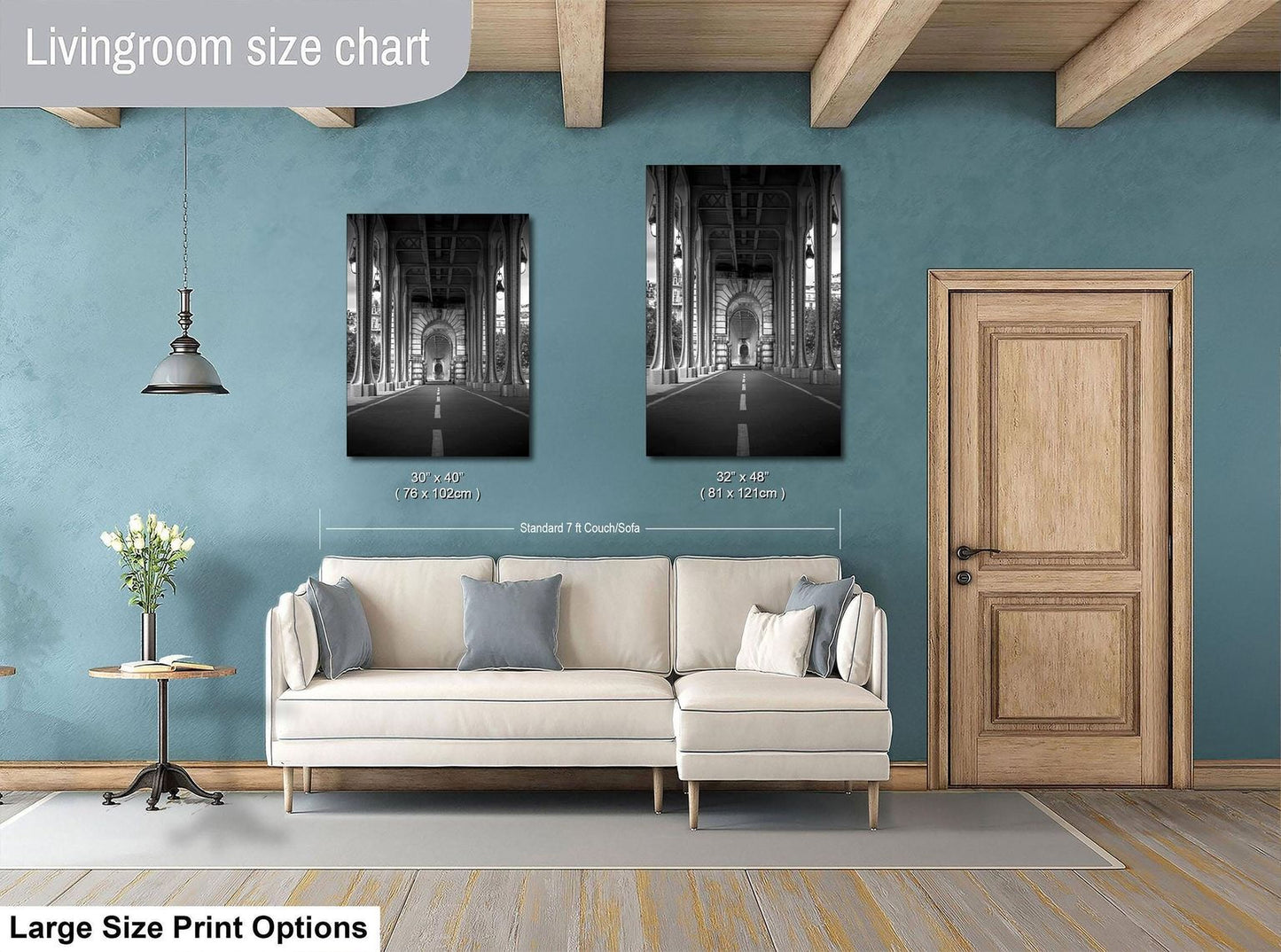 a living room with a white sofa, a wooden door, and a framed photograph of a hallway on the wall.
