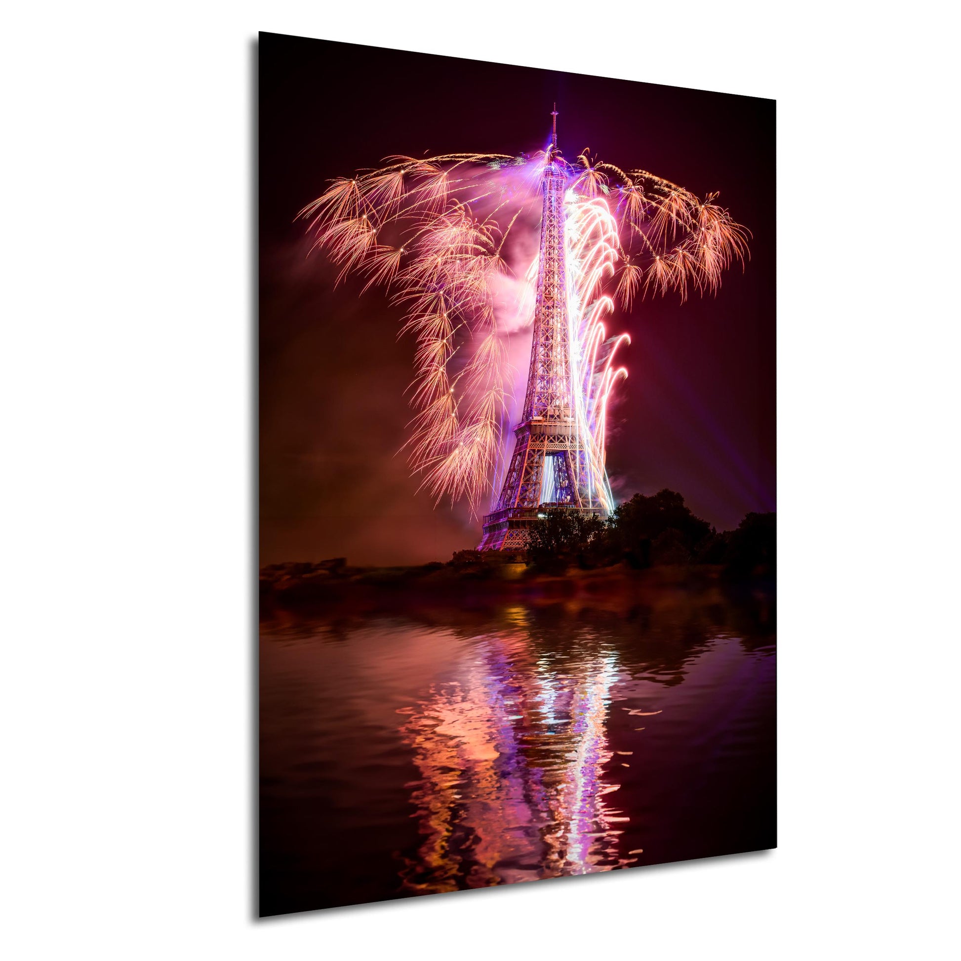 a tall tower with a large, colorful fireworks display lighting up the night sky above it, reflected in the water below.