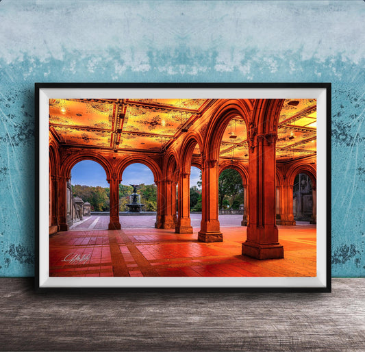 A framed photograph of a grand, ornate building with arched doorways and columns, illuminated by warm lighting, creating a visually striking and inviting scene.