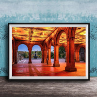 A framed photograph of a grand, ornate building with arched doorways and columns, illuminated by warm lighting, creating a visually striking and inviting scene.