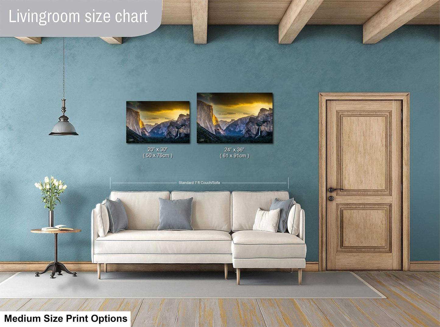 a living room with a white sofa and a wooden door. Above the sofa, there is a livingroom size chart that provides the dimensions of two framed landscape paintings hanging on the wall.
