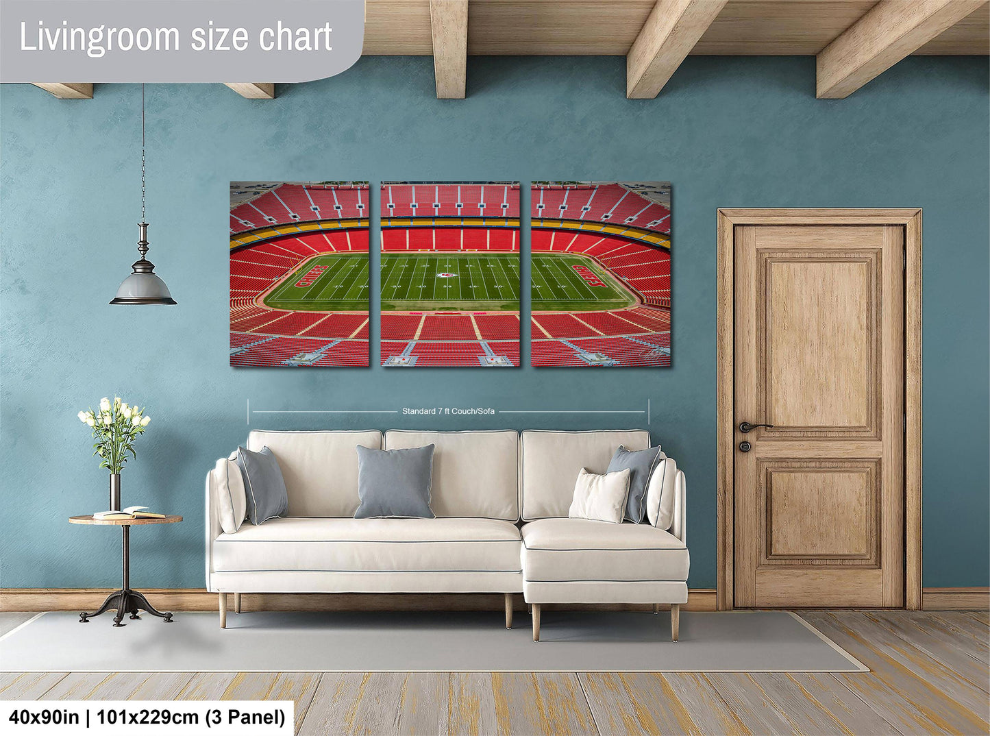 The image is a living room with a large, three-panel living room size chart on the wall. The chart displays the dimensions of the living room in feet and inches, with the largest panel indicating the width of the room. The living room is furnished with a white sofa and a wooden door, and there is a potted plant and a vase on a table nearby.