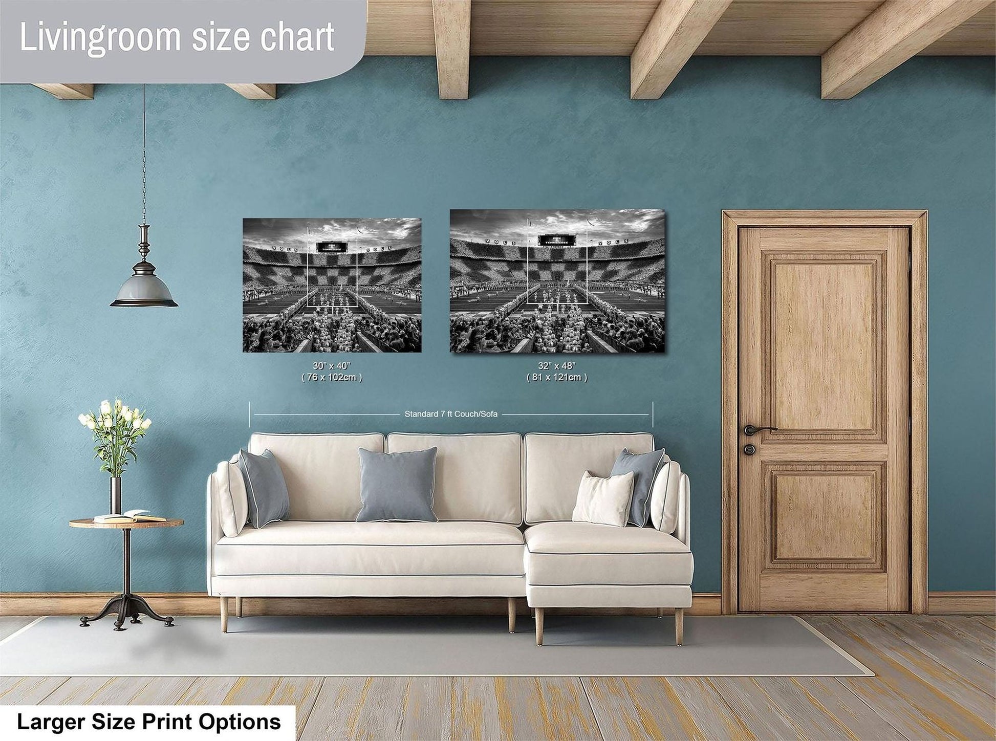a living room with a white sofa, a wooden door, and a framed photograph of a stadium or arena. The living room appears to be designed for relaxation and comfort, with a focus on the seating area and the artwork on the wall.