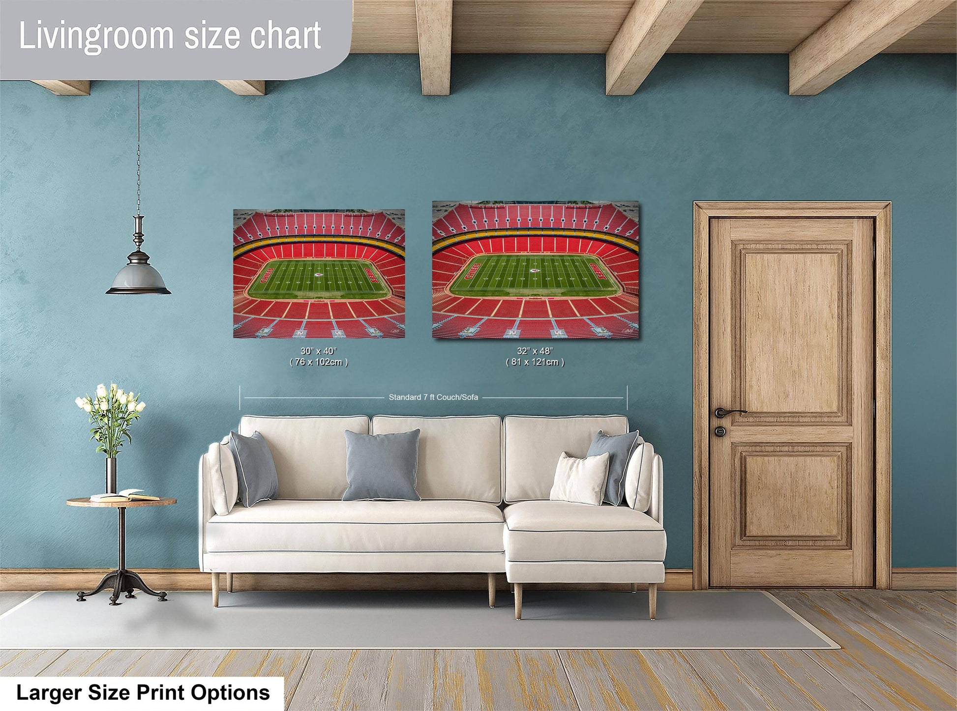 a living room with a white sofa, a wooden door, and two framed pictures of a stadium on the wall.